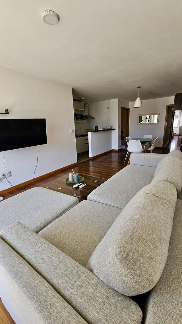 Sala com TV e acesso à cozinha aberta