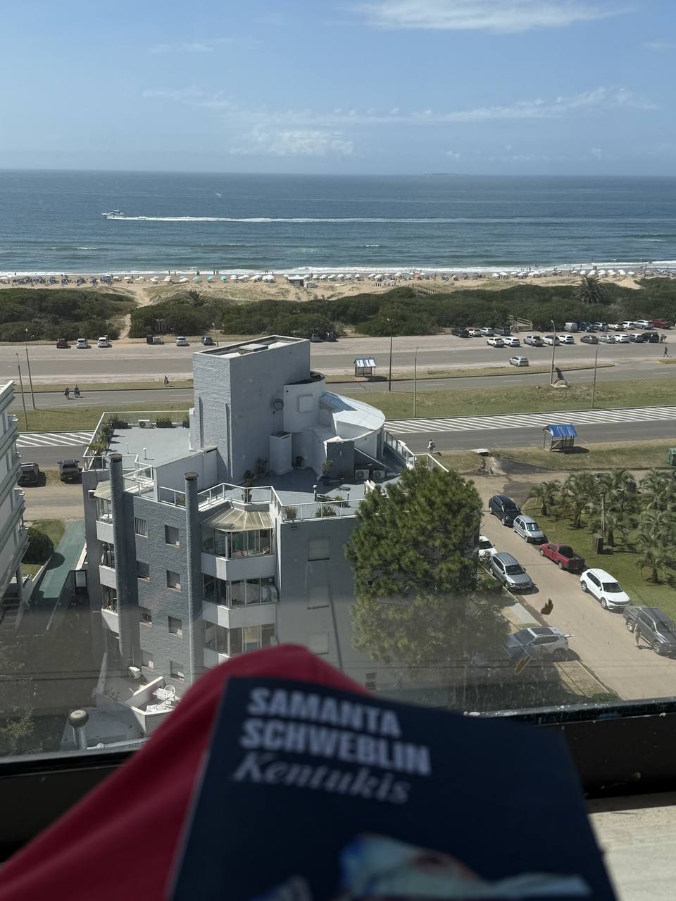 View of sea, beach, coastal road, building