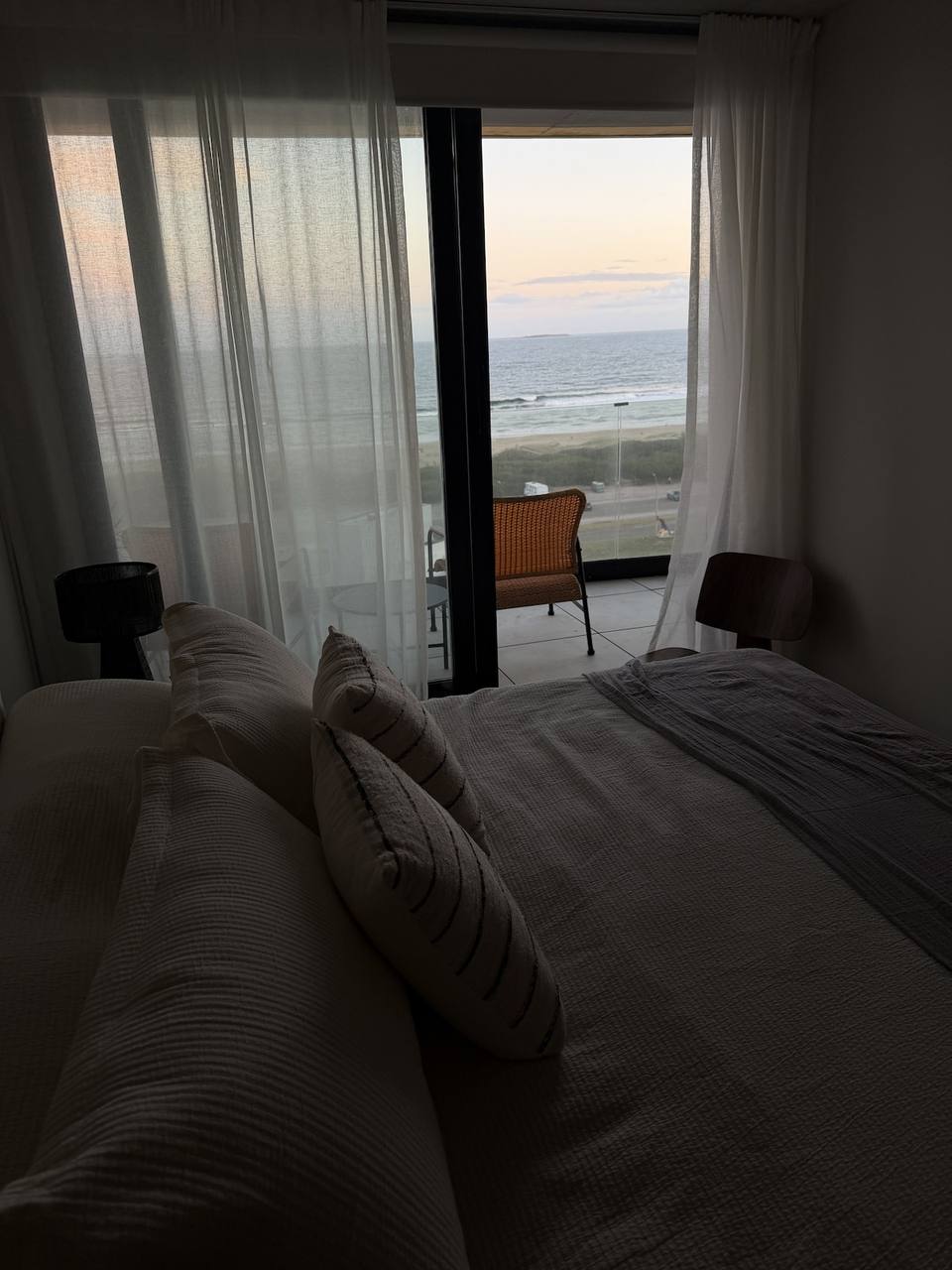 Bed with pillows, ocean view