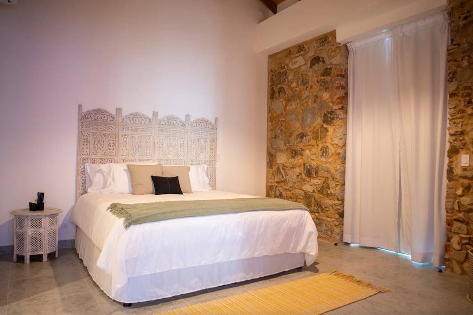 Bedroom with bed and carved headboard