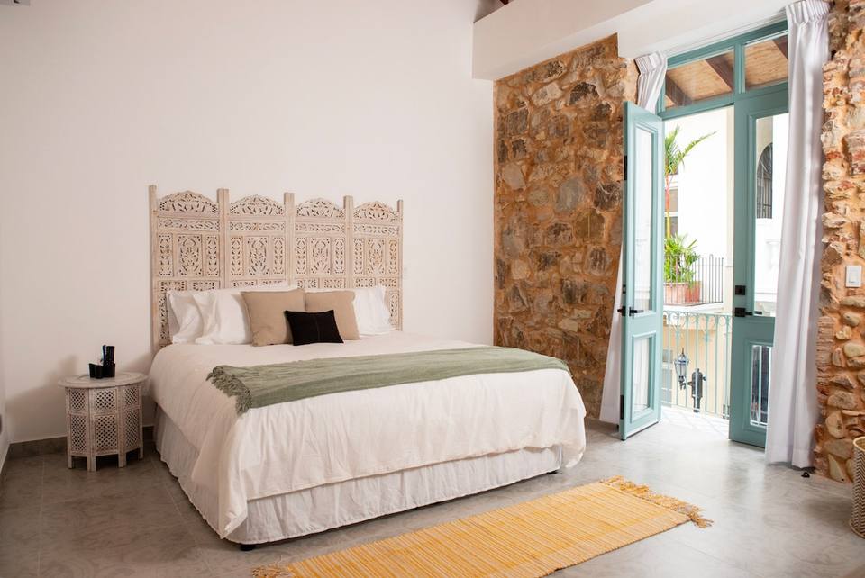 Bedroom with bed and balcony.