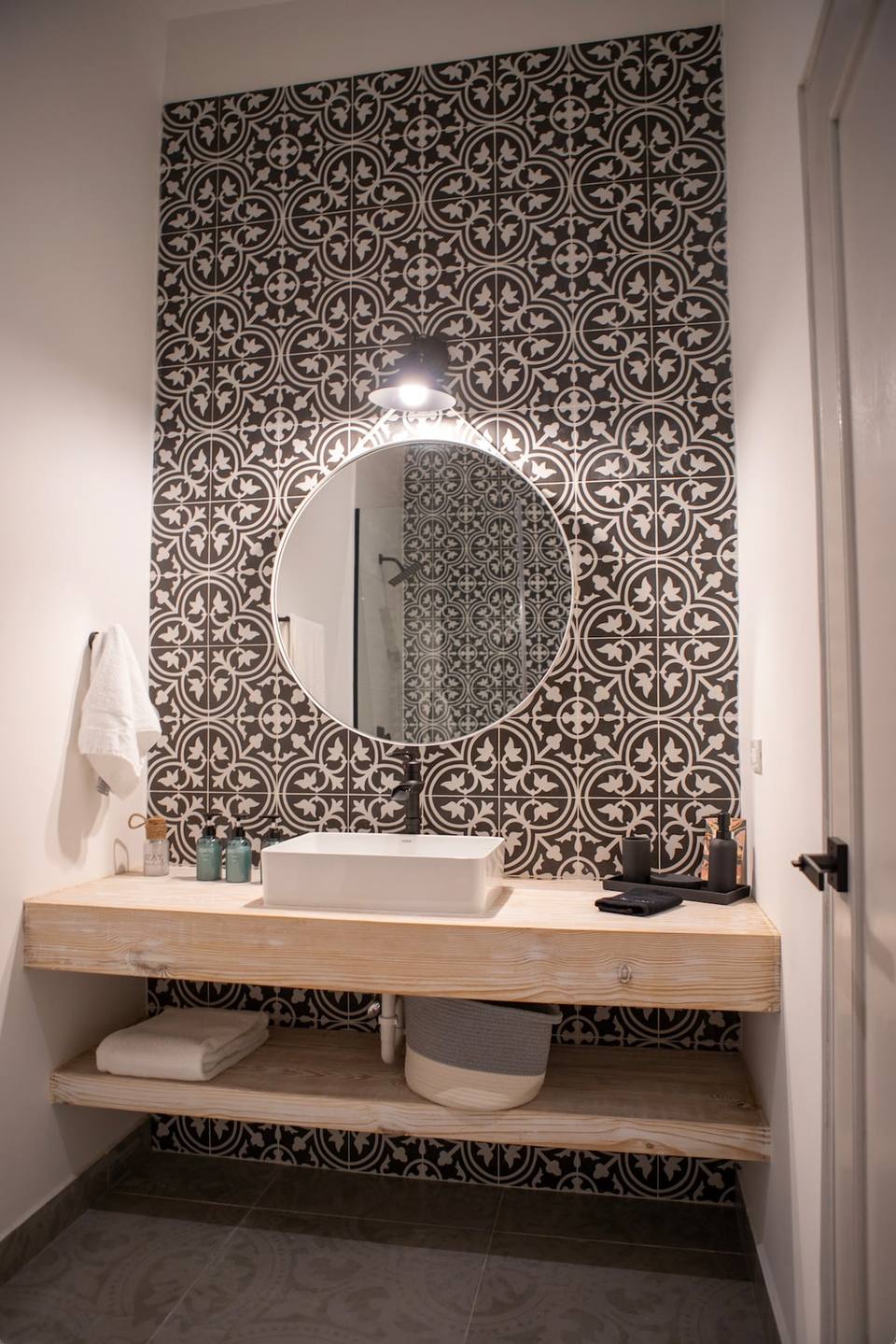 Sink, mirror, and wooden shelf