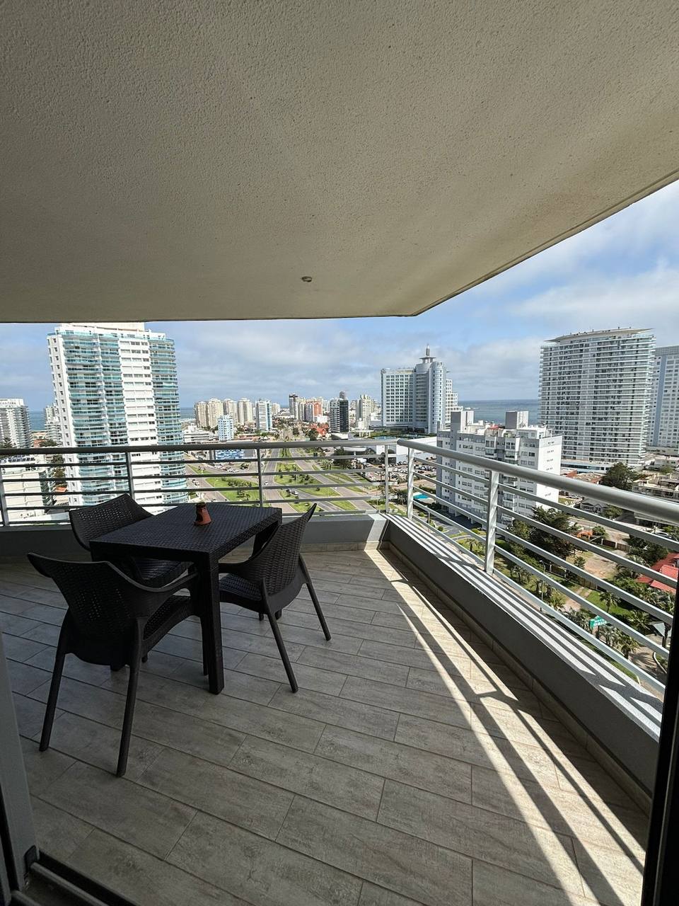 Balcony with table, chairs and urban view