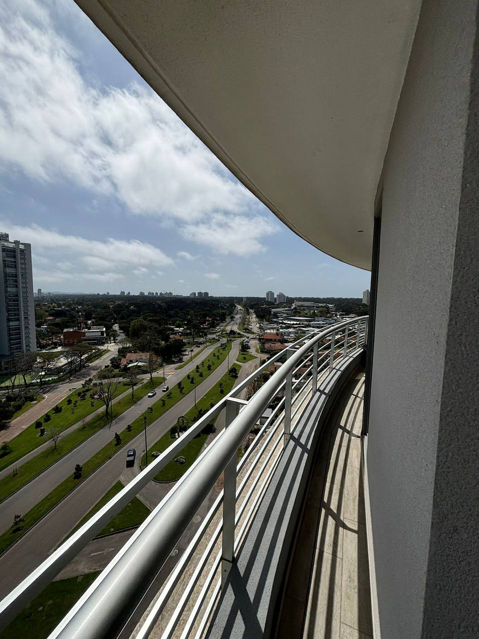 Curved outdoor balcony with urban view