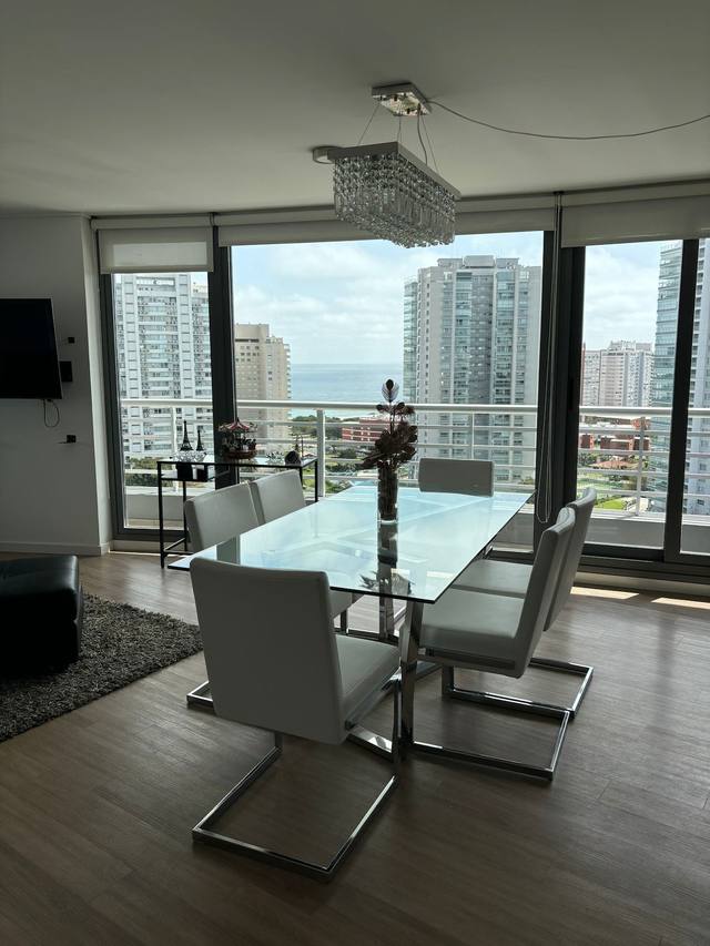 Dining area with glass table and sea view