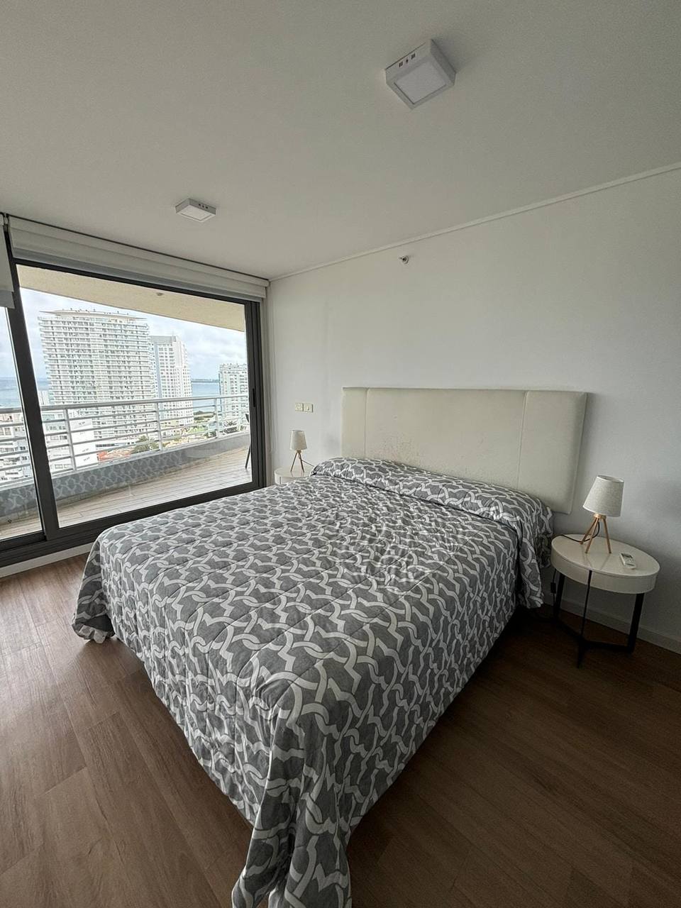 Bedroom with bed, balcony, sea view