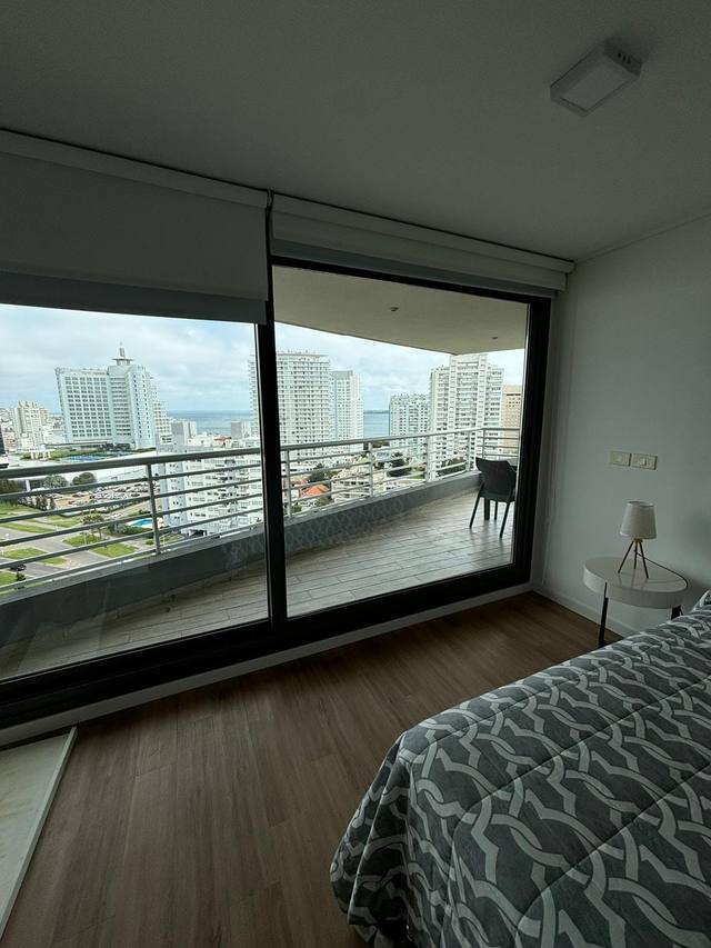Bed with patterned duvet and nightstand