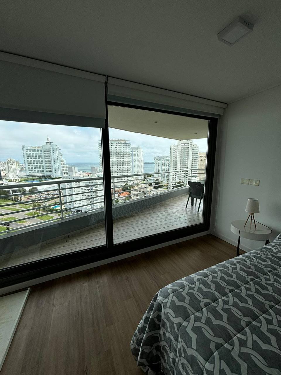 Bed with patterned duvet and nightstand