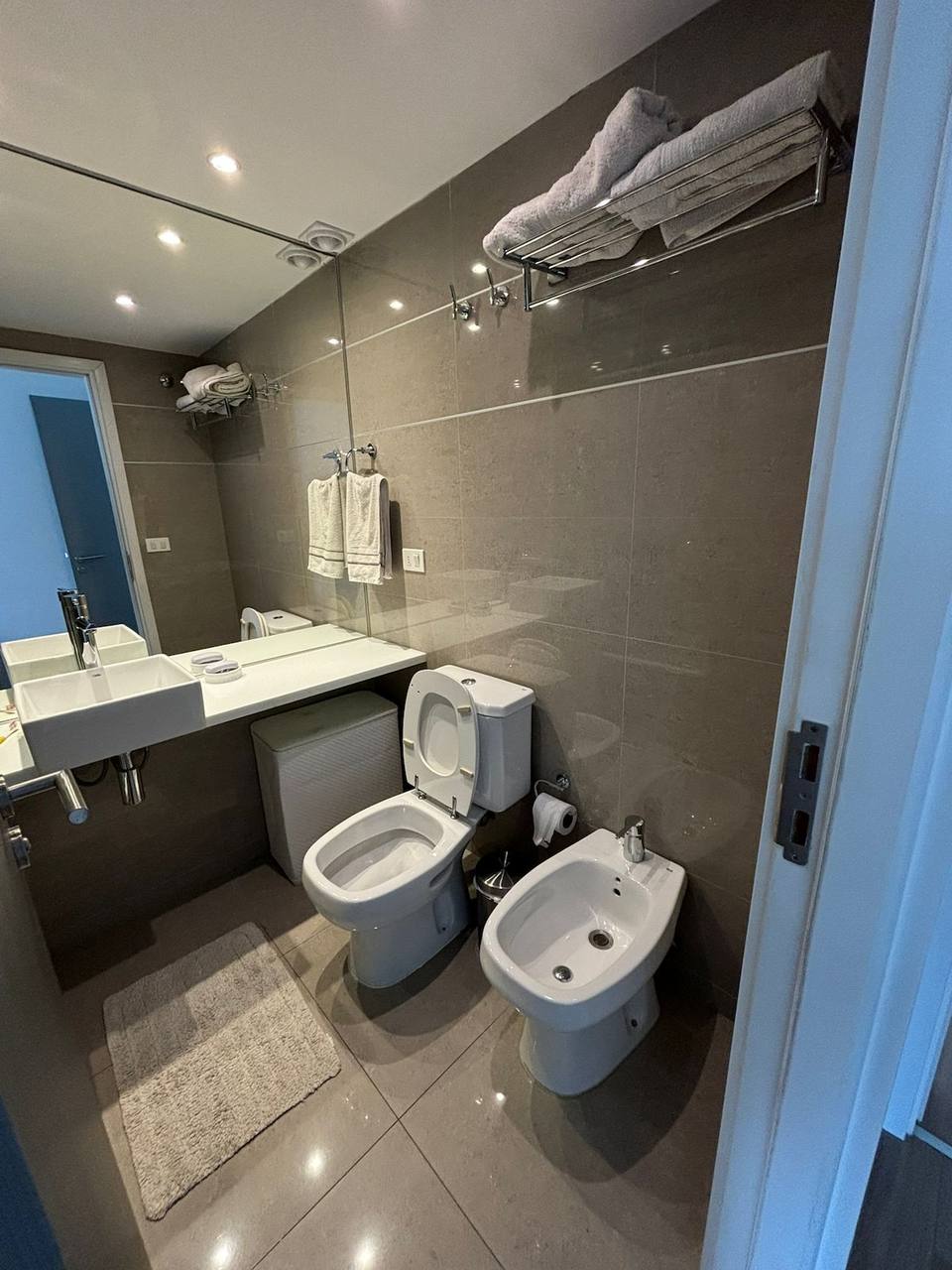 Complete bathroom with toilet, bidet, and sink