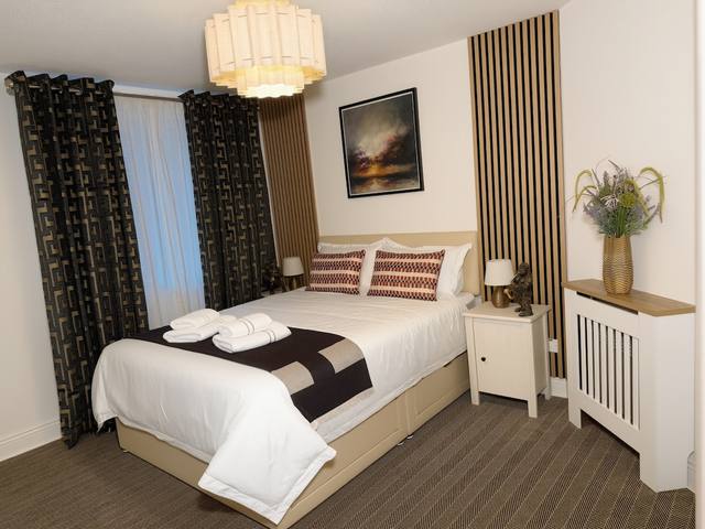 Master bedroom with King bed and wood details