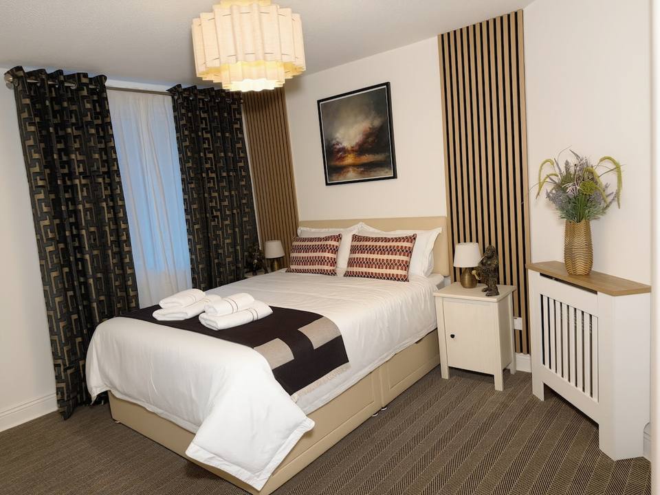 Master bedroom with King bed and wood details