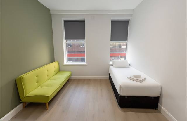 Additional seating area with sofa and single bed
