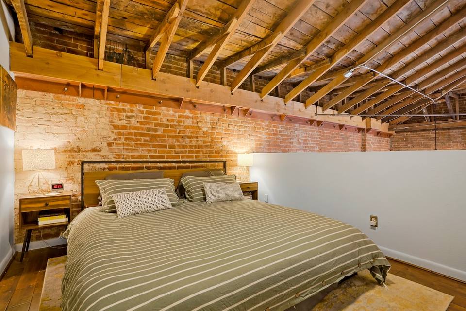 Master bedroom on the upper level with wood details